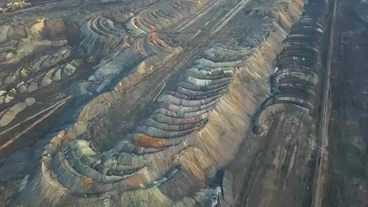 Aerial view of terraced mine waste dumps assessed through geotechnical stability studies
